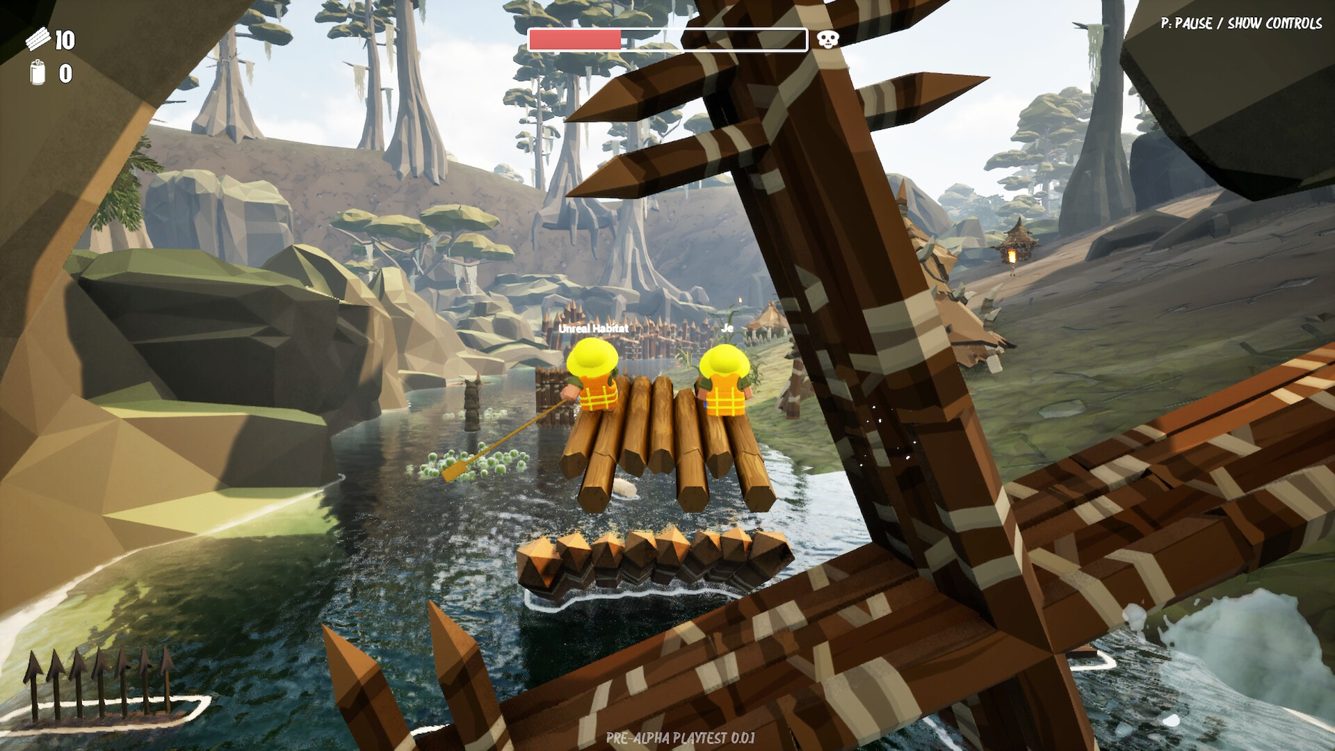Loose logs float beside the raft next to a wooden spike barricade